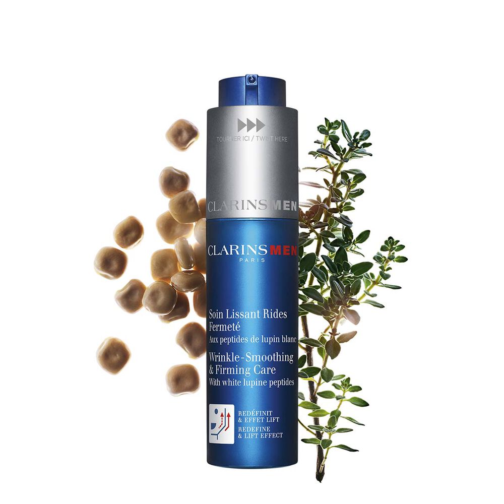 Packshot of the men's anti-aging care by Clarins next to white lupines on a light blue background to emphasize its key ingredient.