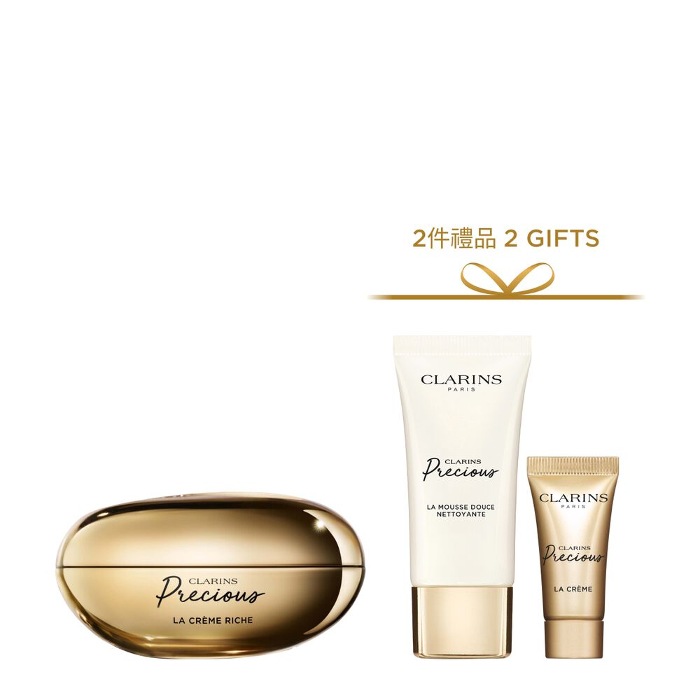 Packshot of Clarins Precious Rich Cream close to a Moonlight flower on dark background.