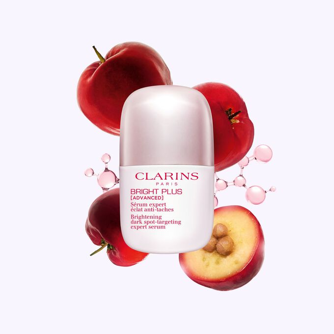 Packshot of Clarins Brightening Vitamin C-Derived Serum placed beside acerola fruits and a niacinamide molecule.