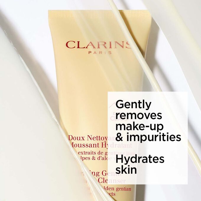 Packshot of the yellow tube of Clarins hydrating facial foaming cleanser under foam with text about its soothing effects