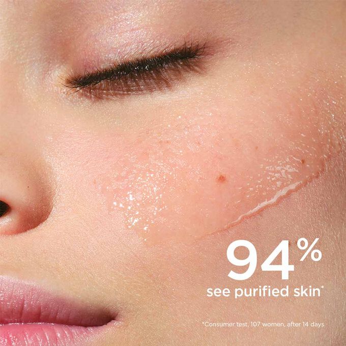 Focus on the lotion application on a woman's cheek to illustrated that 94% of testers find their skin purified
