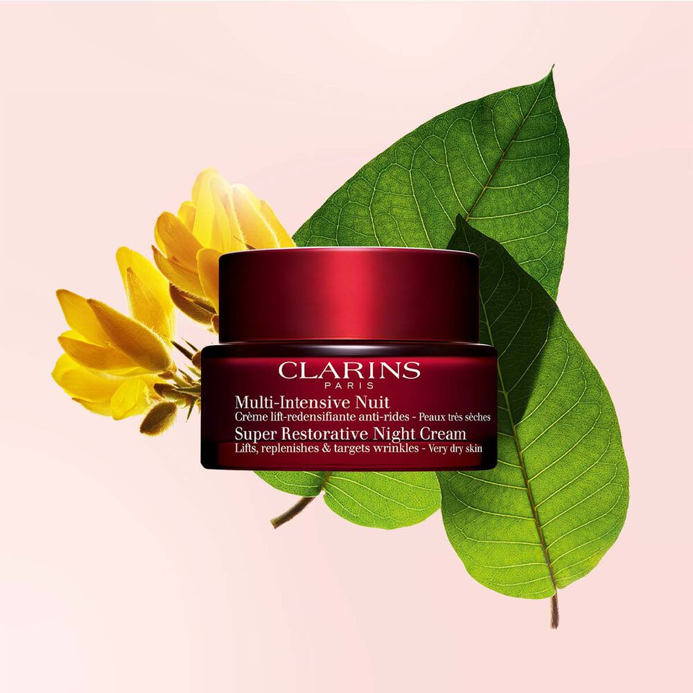 Packshoot of Clarins Super Restorative Night Cream for Dry skin in front of a Ajonc flower and Harangana leaves