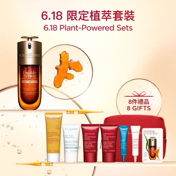 A 70ml bottle of Clarins Double Serum Light Texture among turmeric and proven&ccedil;al reed leaves against an orange background.