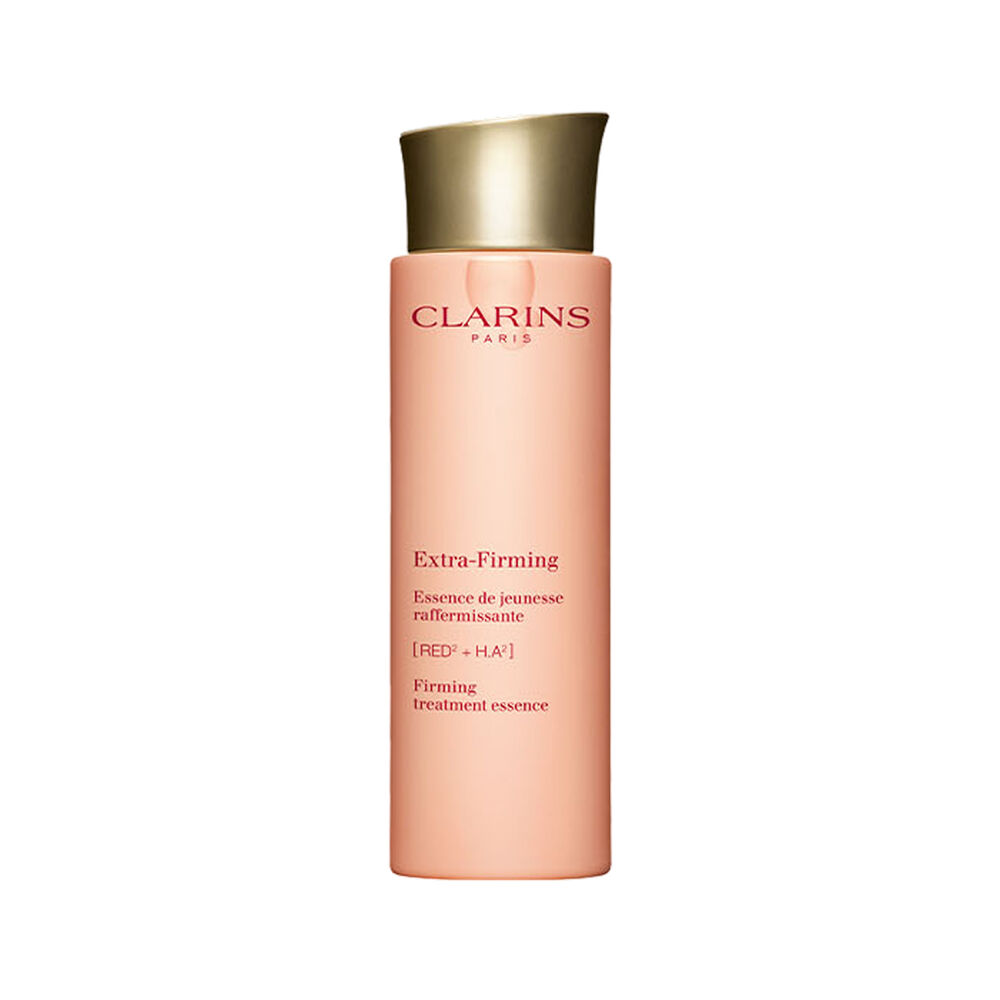 Packshot of Clarins Extra Firming Treatment Essence for all skin types, alongside mitracarpus plant.