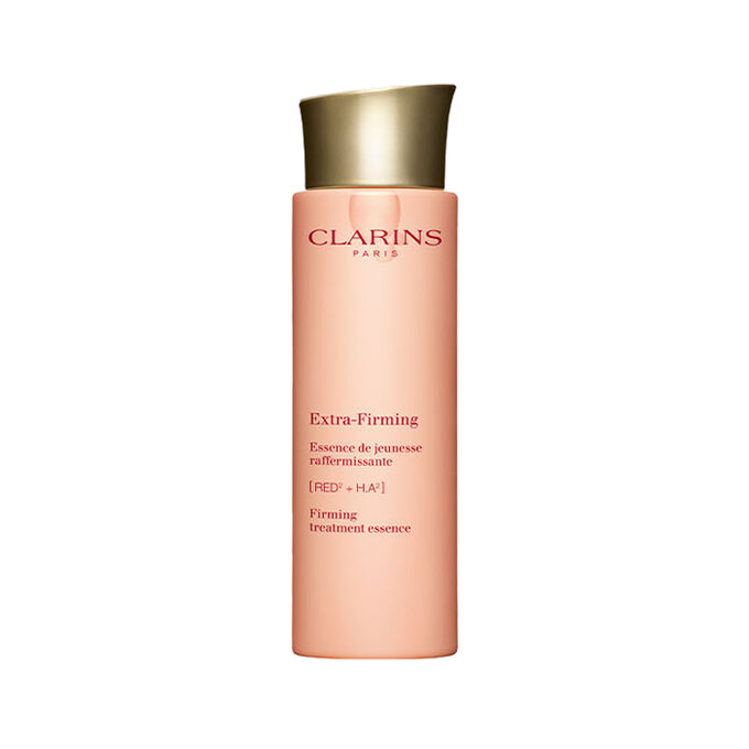 Packshot of Clarins Extra Firming Treatment Essence for all skin types, alongside mitracarpus plant.